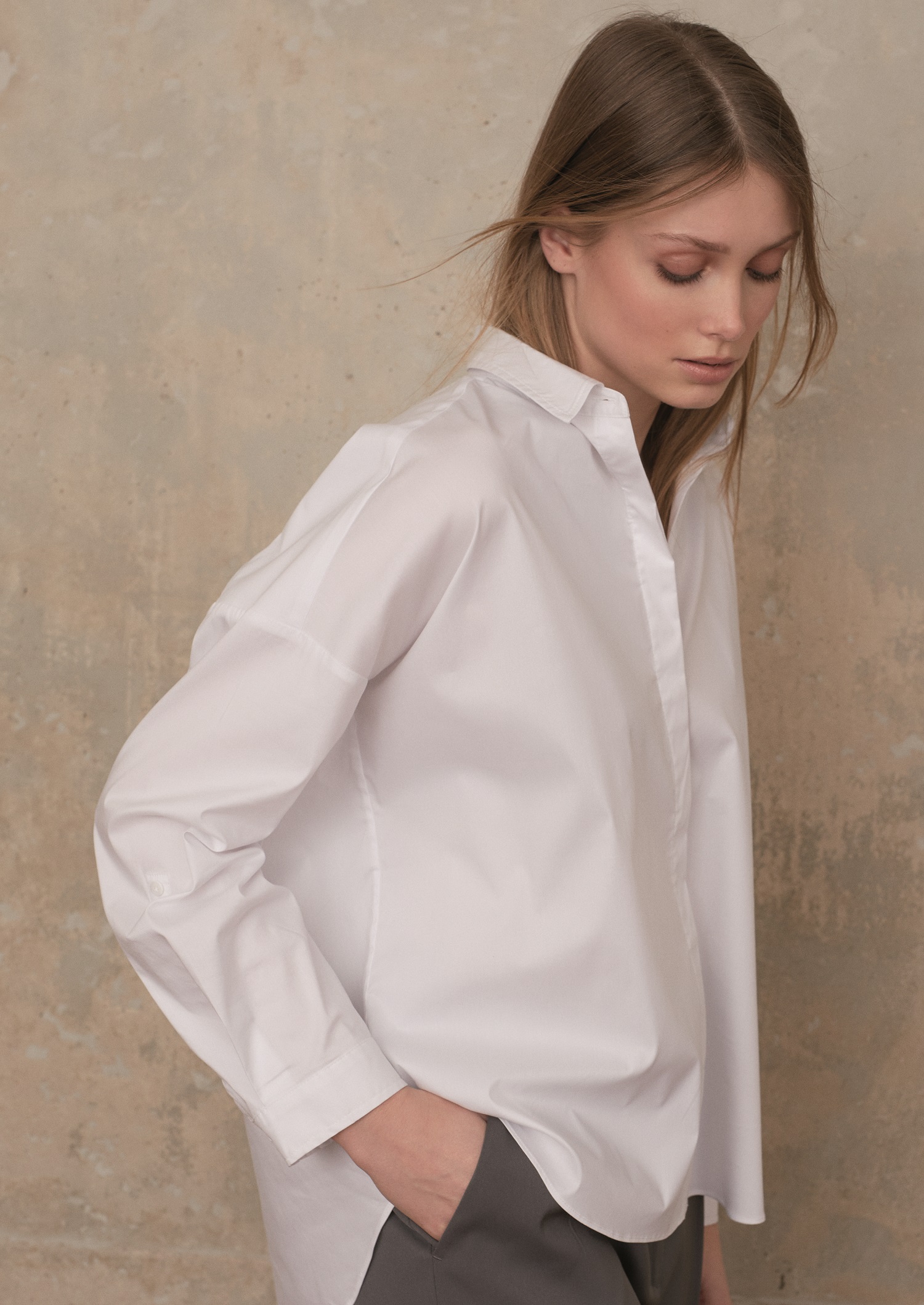 Model trägt weisse Oversized-Bluse